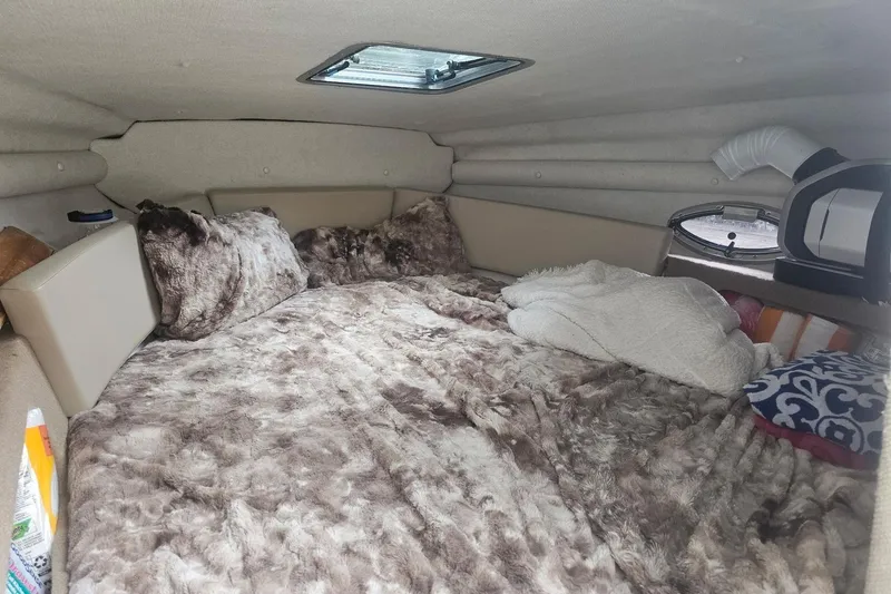 Slide: The Image of Cozy cabin interior of 2014 Chaparral 225 SSi with plush bedding and pillows. - 8