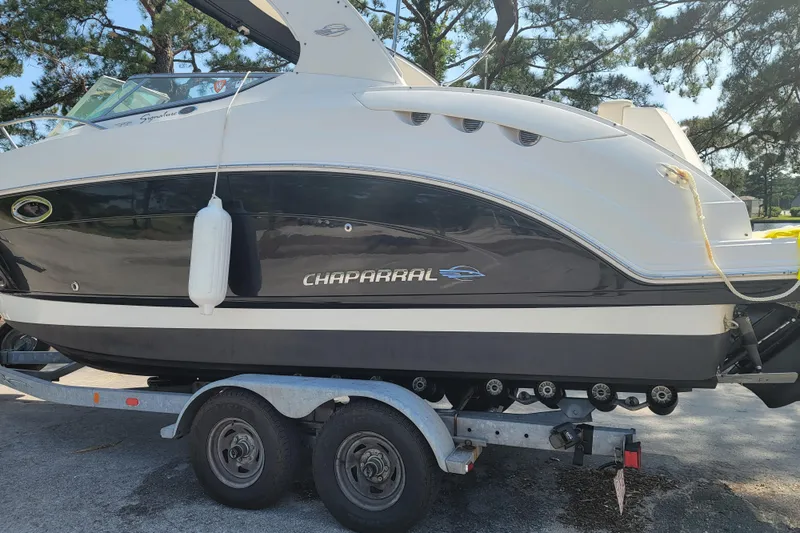 The Image of 2008 Chaparral Signature 250 boat on trailer, parked outdoors with trees in background. - 0