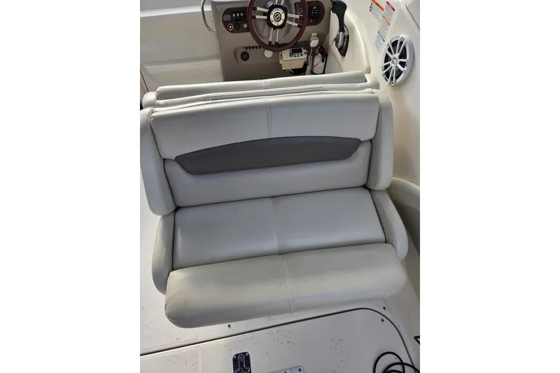 Slide: The Image of 2008 Chaparral Signature 250 boat interior with beige seating and steering console. - 10