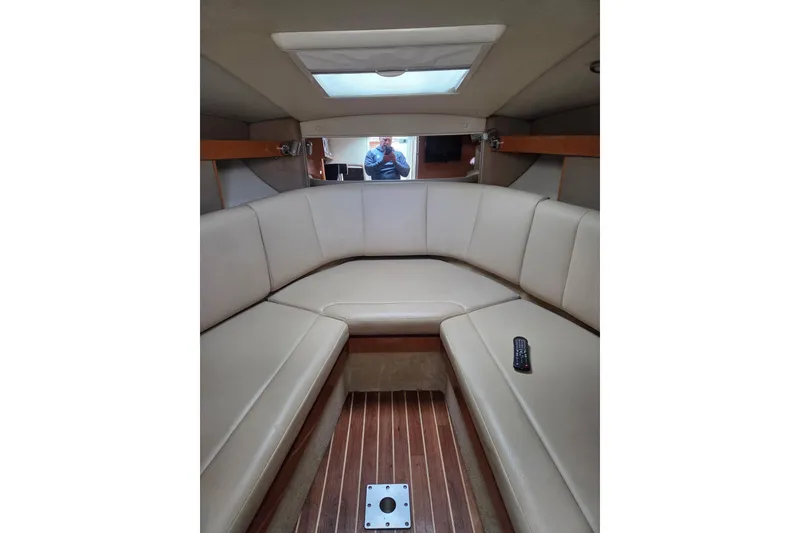 Slide: The Image of 2008 Chaparral Signature 250 cabin interior with beige seating and wooden flooring. - 4