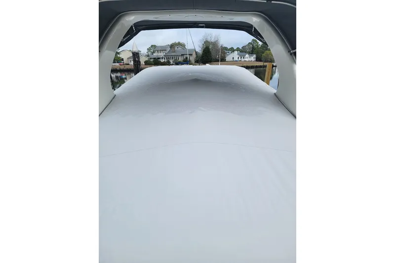 Slide: The Image of 2008 Chaparral Signature 250 boat interior with covered seating area, dockside view. - 7