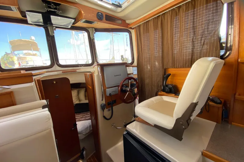 Slide: The Image of 2013 Ranger Tugs R-29 S interior with helm, seating, and navigation equipment. - 12
