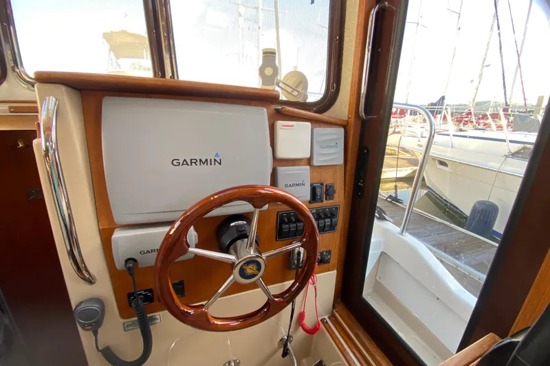 Slide: The Image of 2013 Ranger Tugs R-29 S helm with Garmin navigation system and wooden steering wheel. - 13