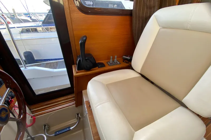 Slide: The Image of Interior of 2013 Ranger Tugs R-29 S boat with helm seat and controls. - 14