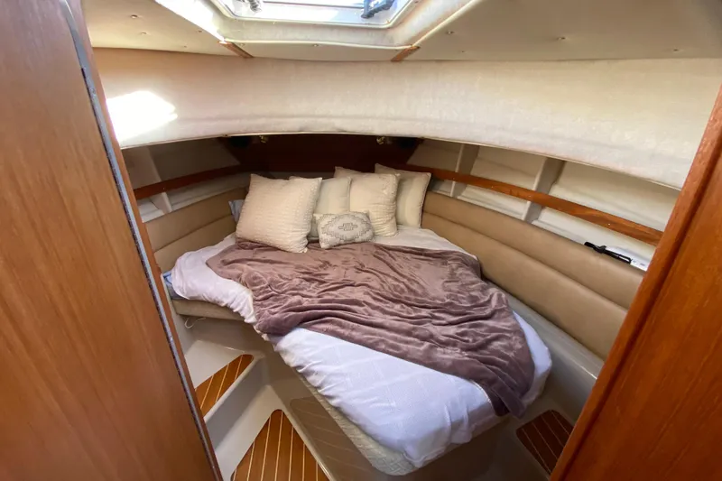 Slide: The Image of Cozy cabin interior of 2013 Ranger Tugs R-29 S with plush bedding and natural light. - 15