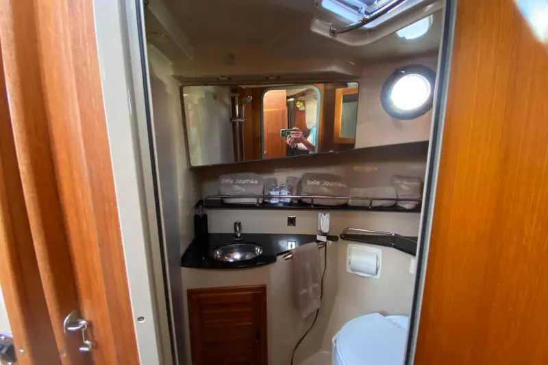 Slide: The Image of 2013 Ranger Tugs R-29 S bathroom with sink, mirror, and porthole window. - 17