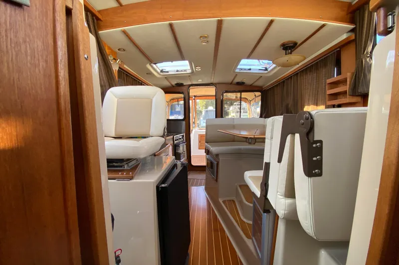 Slide: The Image of Interior of 2013 Ranger Tugs R-29 S boat with seating and wood accents. - 18