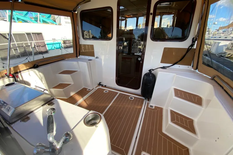 Slide: The Image of 2013 Ranger Tugs R-29 S boat interior with teak flooring and seating area. - 6