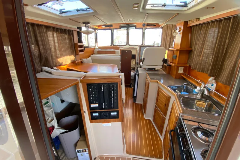 Slide: The Image of Interior of 2013 Ranger Tugs R-29 S boat with kitchen and seating area. - 8