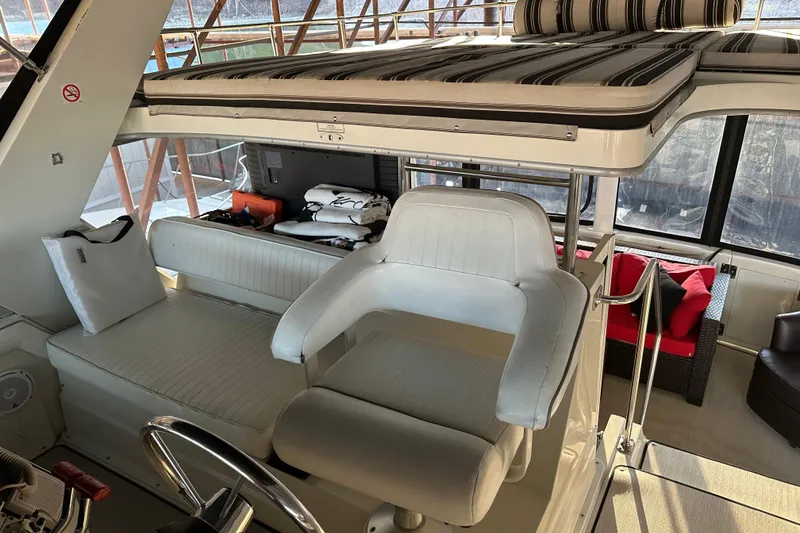 Slide: The Image of 1995 Carver 440 Aft Cabin Motor Yacht interior with white seating and striped cushions. - 14