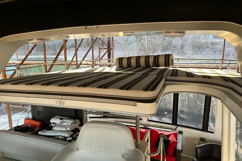 Slide: The Image of 1995 Carver 440 Aft Cabin Motor Yacht interior with striped cushions and seating area. - 15