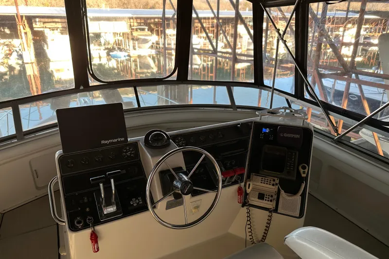 Slide: The Image of 1995 Carver 440 Aft Cabin Motor Yacht helm with navigation equipment and steering wheel. - 17