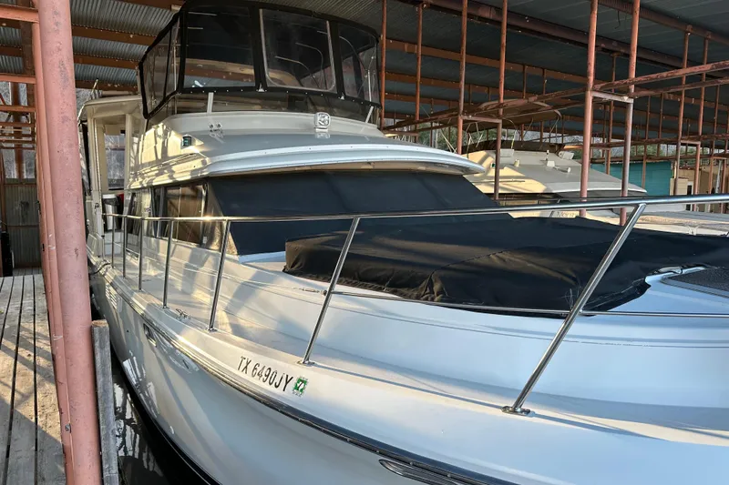 Slide: The Image of 1995 Carver 440 Aft Cabin Motor Yacht docked in a covered marina. - 19