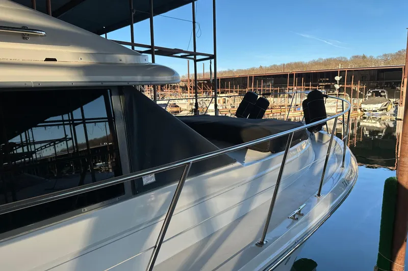 Slide: The Image of 1995 Carver 440 Aft Cabin Motor Yacht docked in a marina, side view. - 2