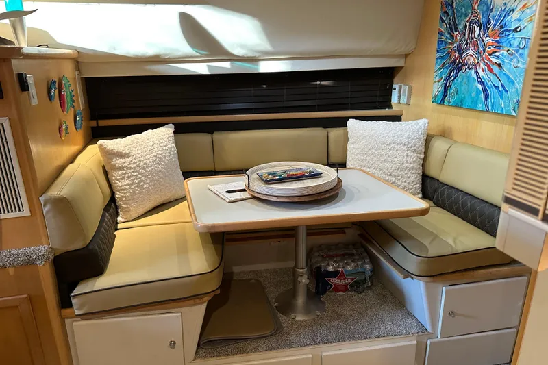 Slide: The Image of Cozy dining area in a 1995 Carver 440 Aft Cabin Motor Yacht with plush seating and decor. - 29
