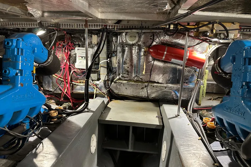 Slide: The Image of Engine room of 1995 Carver 440 Aft Cabin Motor Yacht with visible machinery and wiring. - 31