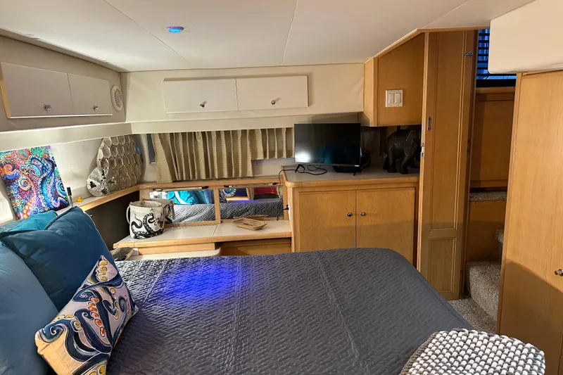 Slide: The Image of Cozy bedroom in 1995 Carver 440 Aft Cabin Motor Yacht with modern decor and TV. - 46