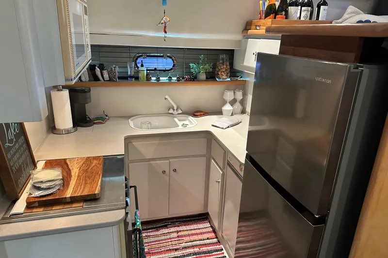 Slide: The Image of Compact kitchen in 1995 Carver 440 Aft Cabin Motor Yacht with modern appliances and decor. - 7