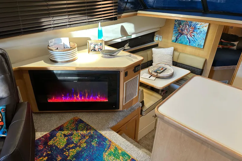 Slide: The Image of Interior of 1995 Carver 440 Aft Cabin Motor Yacht with modern decor and electric fireplace. - 9