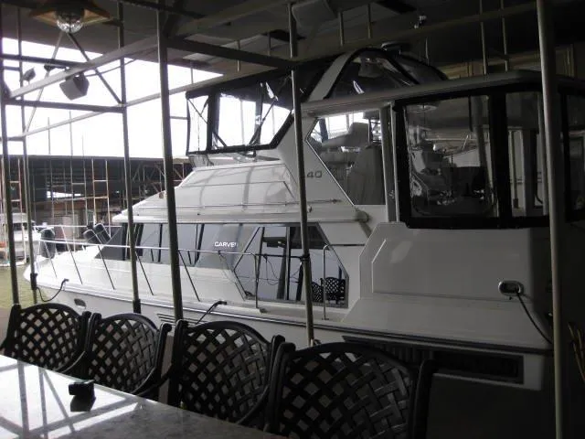 The Image of 1995 Carver 440 Aft Cabin Motor Yacht in a covered marina. - 1
