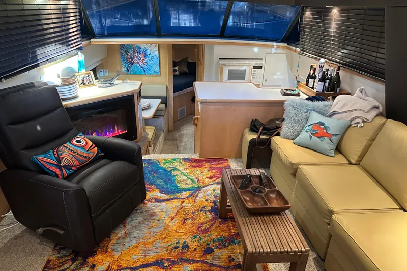 Slide: The Image of Interior of 1995 Carver 440 Aft Cabin Motor Yacht with cozy seating and decor. - 10