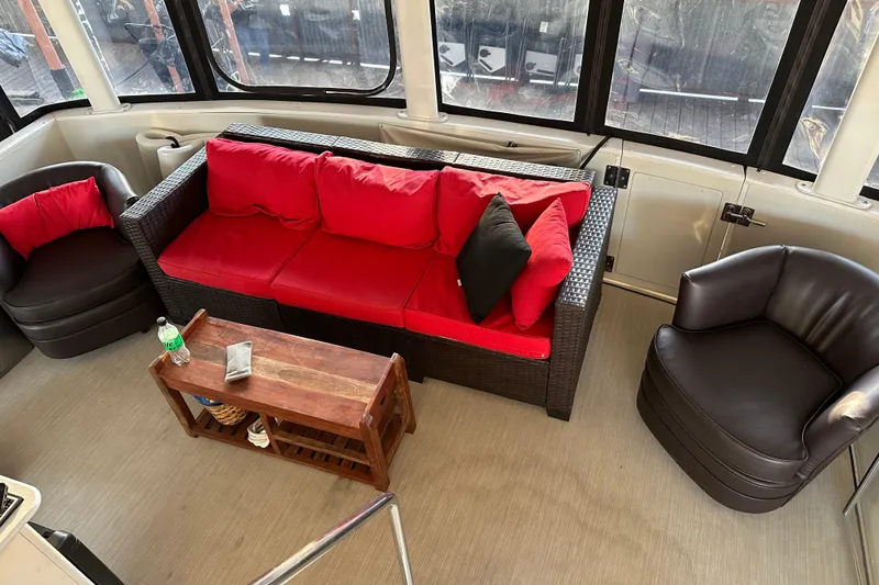 Slide: The Image of 1995 Carver 440 Aft Cabin Motor Yacht interior with red and black seating arrangement. - 12