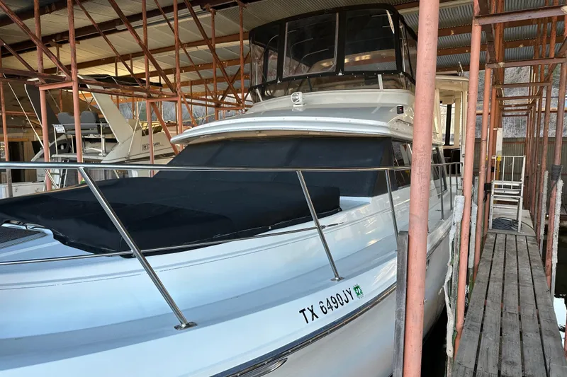 Slide: The Image of 1995 Carver 440 Aft Cabin Motor Yacht docked in a covered marina. - 22