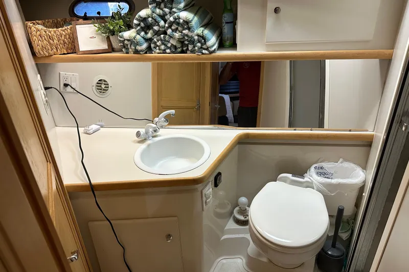Slide: The Image of Bathroom interior of 1995 Carver 440 Aft Cabin Motor Yacht, featuring sink and toilet. - 25