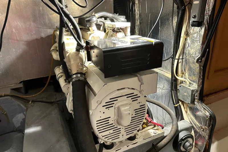 Slide: The Image of Engine room of 1995 Carver 440 Aft Cabin Motor Yacht, showcasing mechanical components. - 33