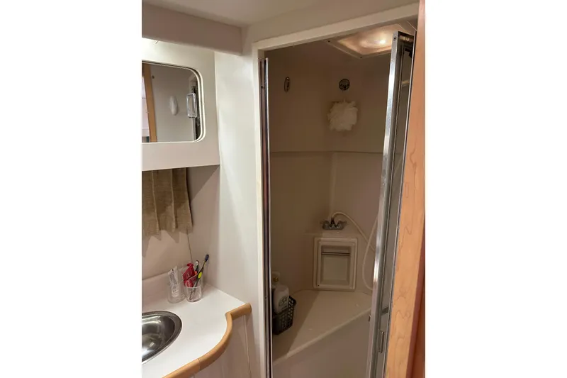 Slide: The Image of Bathroom interior of 1995 Carver 440 Aft Cabin Motor Yacht, featuring sink and shower. - 47