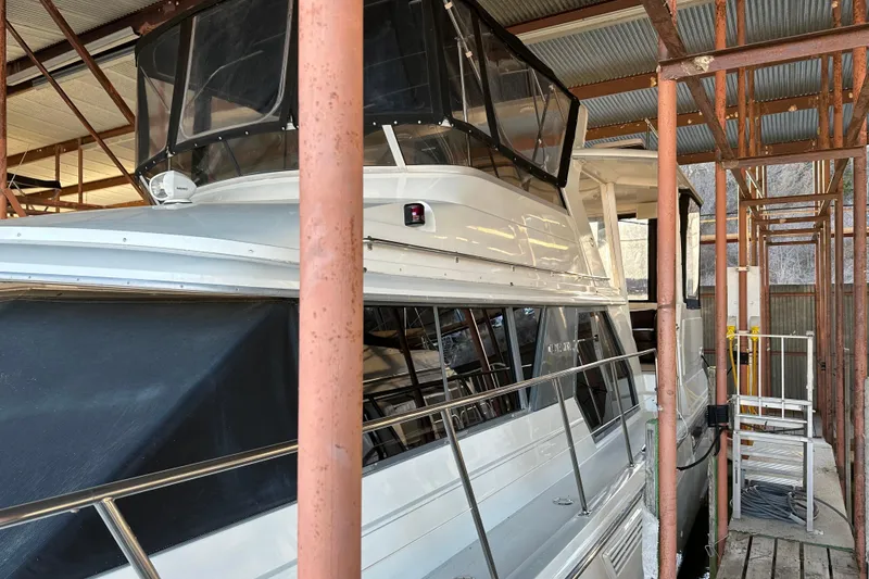 Slide: The Image of 1995 Carver 440 Aft Cabin Motor Yacht docked in a covered marina. - 5