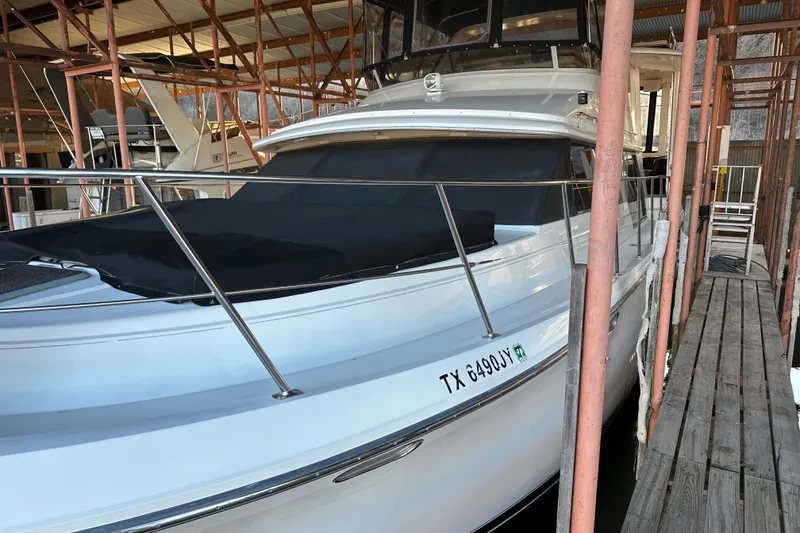 Slide: The Image of 1995 Carver 440 Aft Cabin Motor Yacht docked in a marina. - 6
