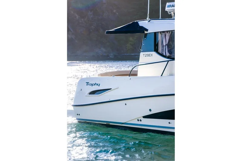 Slide: The Image of 2026 Trophy T29EX Explorer boat on water, side view, sunlight reflecting. - 12