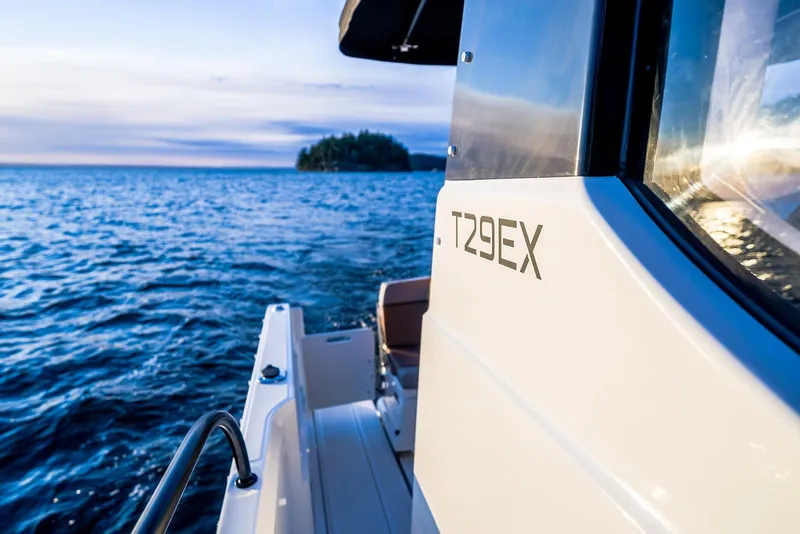 Slide: The Image of 2026 Trophy T29EX Explorer boat on serene water at sunset. - 13