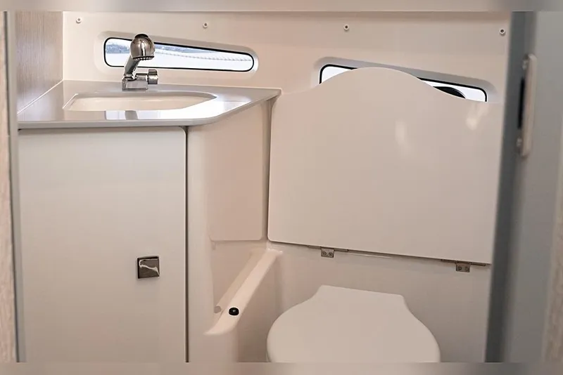 Slide: The Image of Compact bathroom in 2026 Trophy T29EX Explorer boat with sink and toilet. - 19