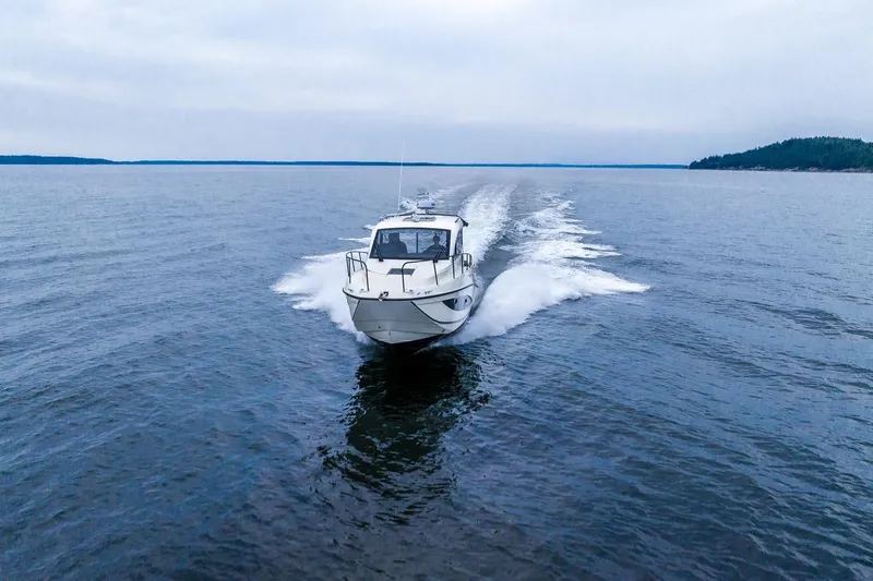 Slide: The Image of 2026 Trophy T29EX Explorer boat cruising on open water. - 2