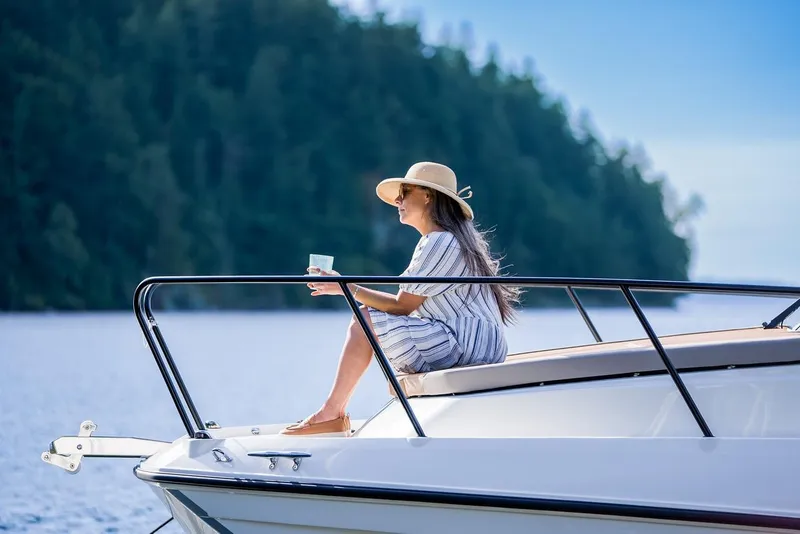 Slide: The Image of Woman relaxing on 2026 Trophy T29EX Explorer boat, enjoying scenic lake view. - 23