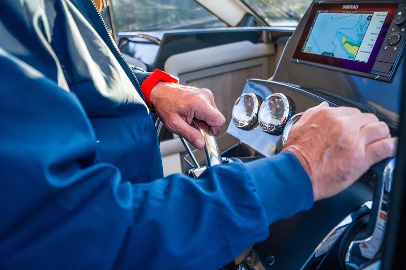 Slide: The Image of Person steering 2026 Trophy T29EX Explorer boat with navigation system visible. - 27