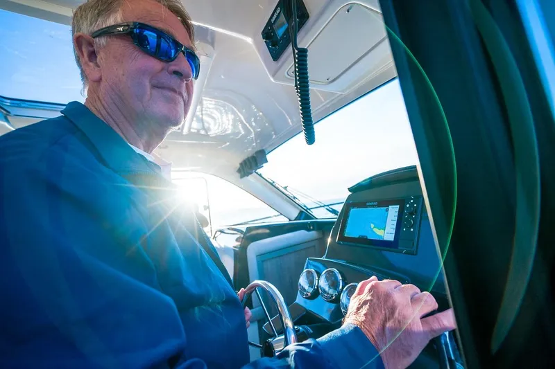 Slide: The Image of Man steering 2026 Trophy T29EX Explorer boat with sunlight and navigation display. - 28