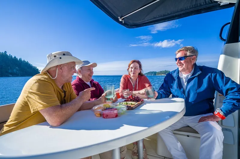 Slide: The Image of Group enjoying a meal on a 2026 Trophy T29EX Explorer boat, scenic ocean backdrop. - 30