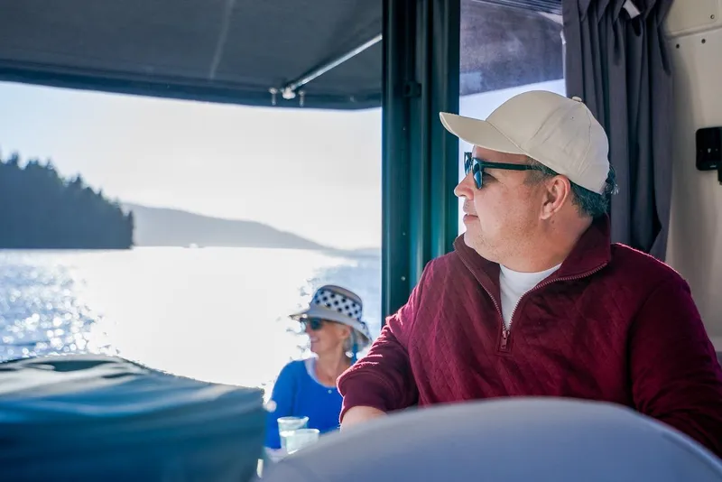 Slide: The Image of Man enjoying a scenic boat ride on Trophy T29EX Explorer, 2026 model. - 33