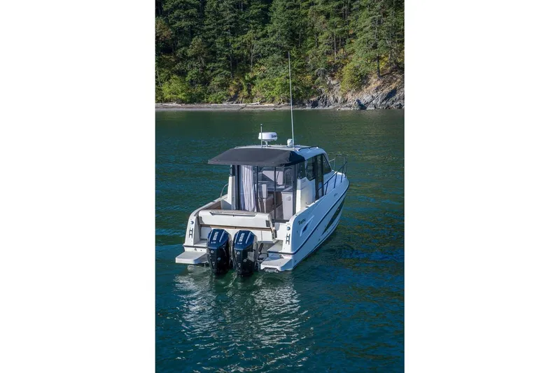 Slide: The Image of 2026 Trophy T29EX Explorer boat on water, forested shoreline in background. - 7