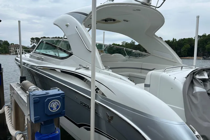 Slide: The Image of 2008 Formula 400 Super Sport boat docked by a serene lake. - 11