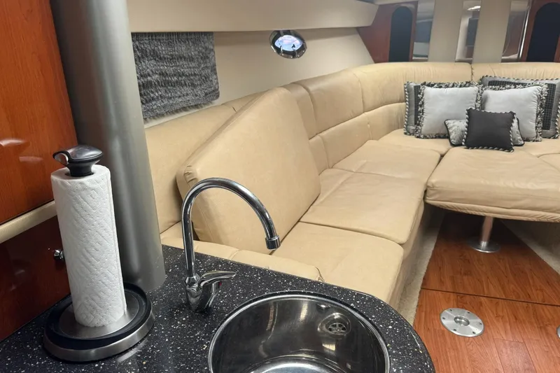 Slide: The Image of 2008 Formula 400 Super Sport yacht interior with beige seating and modern kitchenette. - 22