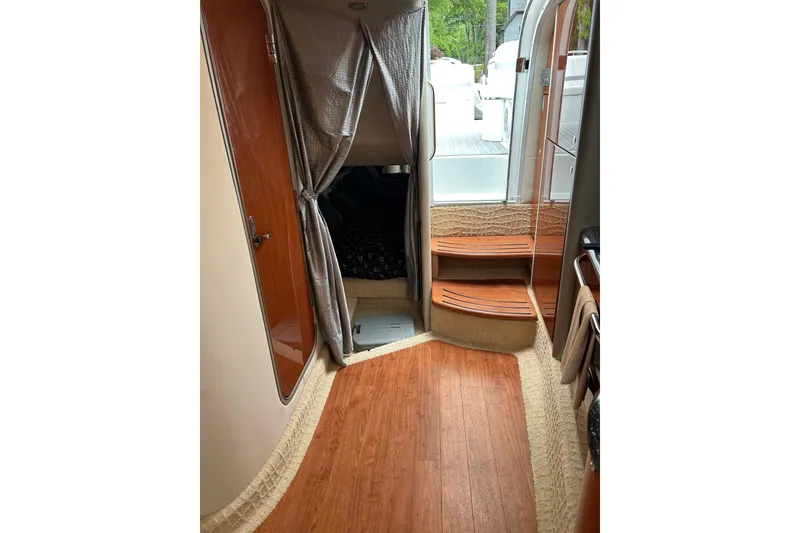 Slide: The Image of Interior of 2008 Formula 400 Super Sport boat with wood flooring and cozy cabin space. - 25