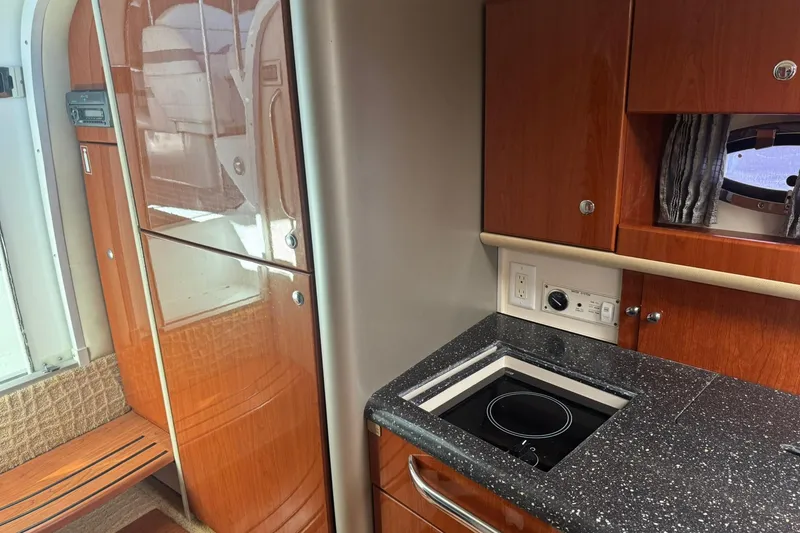 Slide: The Image of 2008 Formula 400 Super Sport yacht interior with kitchenette and wooden cabinetry. - 27