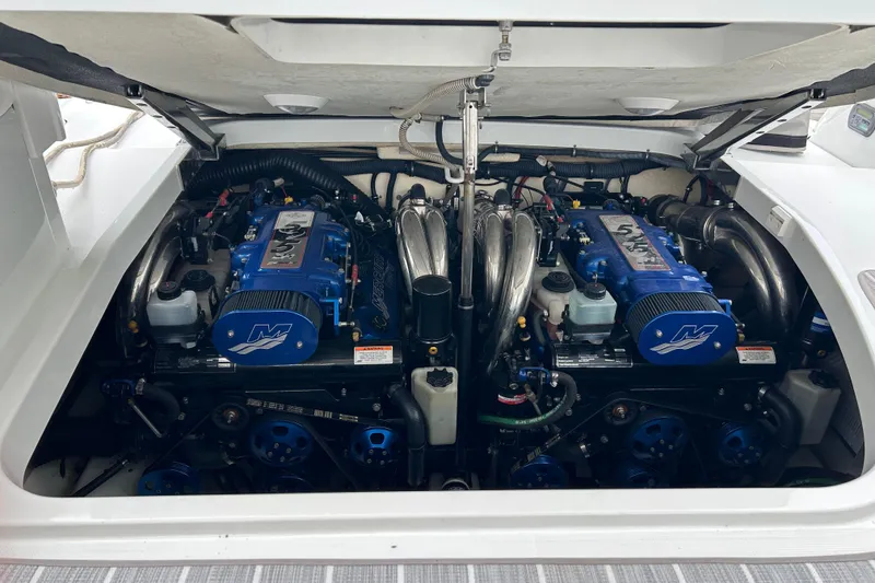 Slide: The Image of Engine compartment of a 2008 Formula 400 Super Sport boat, featuring dual blue engines. - 38