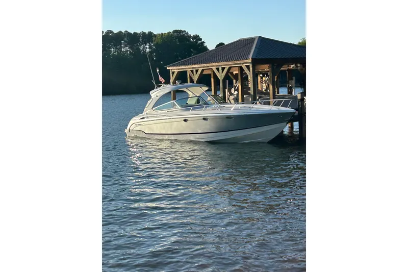 Slide: The Image of 2008 Formula 400 Super Sport boat docked on calm water near a wooden pier. - 5