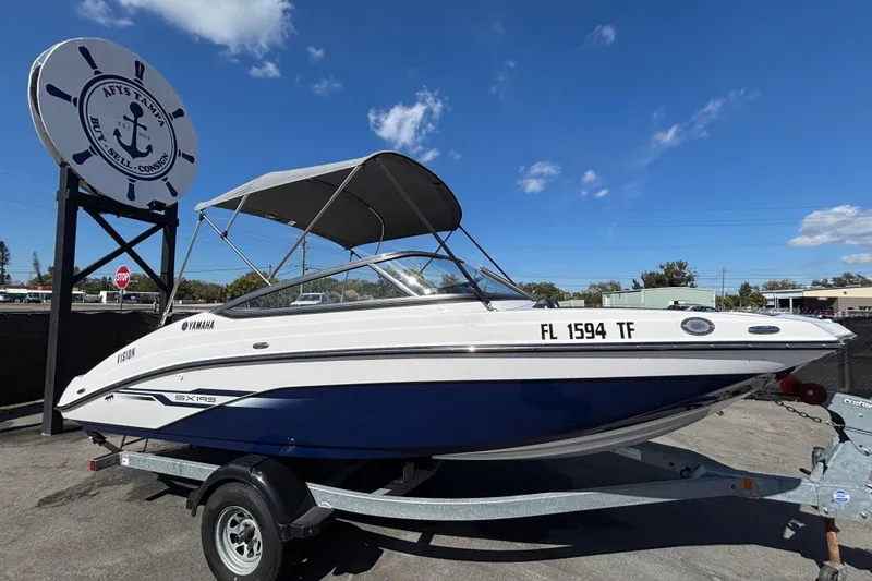 The Image of 2022 Yamaha SX195 boat on trailer under clear blue sky. - 0