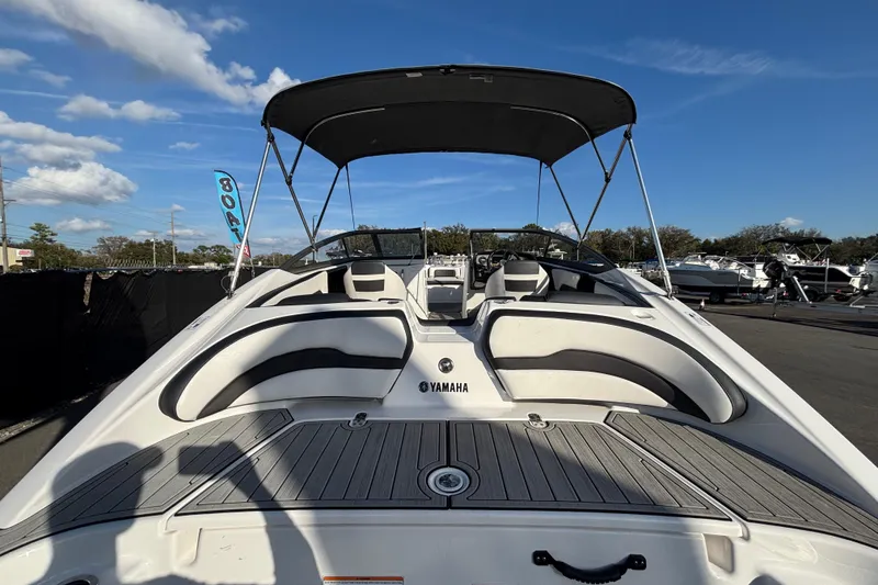 Slide: The Image of 2022 Yamaha Boats SX195 with canopy, docked under clear blue sky. - 11